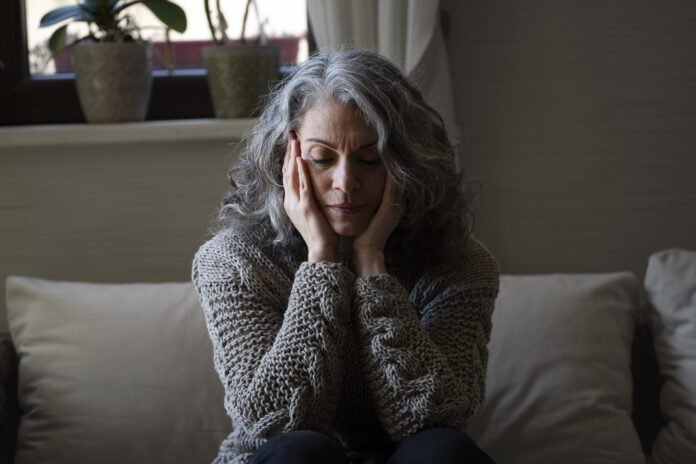 sad-elder-woman-sofa