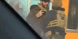 of Alex Pretti recording video on his phone as he was shoved back by a federal agent minutes before being shot and killed. Photograph