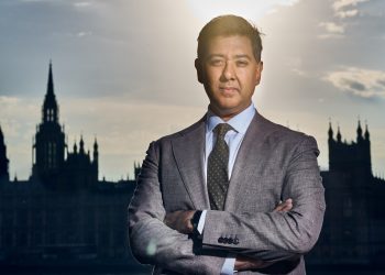 Imran Ahmed, founding CEO of the Center for Countering Digital Hate, standing with arms crossed in front of the London skyline