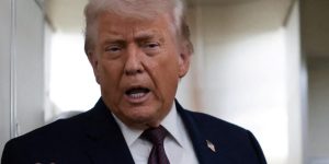 U.S. President Donald Trump speaks to reporters aboard Air Force One