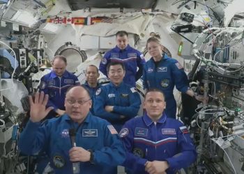 astronauts in blue aboard the ISS