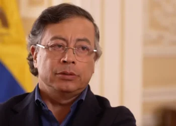 BBC Colombia's President Gustavo Petro wears a serious expression. He is dressed in a dark blue shirt and wears spectacles