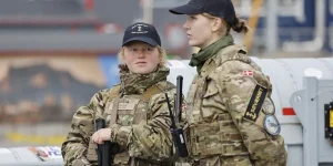 s Two female members of the Royal Danish Navy stand guard on a warship in Nuuk, Greenland