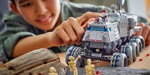 A young boy playing with the Lego Star Wars Republic Juggernaut