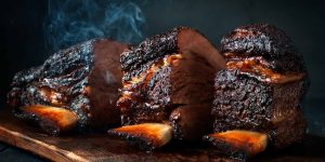 Cut a large piece of smoked beef brisket to the ribs with a dark crust. Classic Texas barbecue
