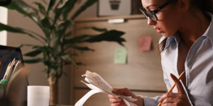 Female accountant calculating tax bills while working on finances in the office Free Photo
