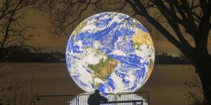 People view artist Luke Jerram's new 'Floating Earth' Debuts In Wigan on November 18, 2021 in Wigan, England