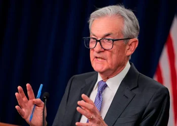 s Jerome Powell seen speaking at a podium. He is motioning with his hands