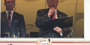 President Donald Trump delivers the Oath of Enlistment alongside Defense Secretary Pete Hegseth, left, during an NFL football game between the Washington Comman