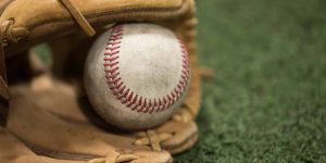 Closeup of Baseball Glove and Baseball on turf