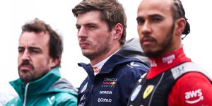 Max Verstappen and Fernando Alonso stand next to Lewis Hamilton