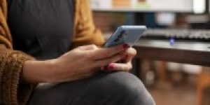 female-employee-holding-mobile-device