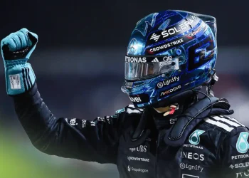 George Russell punches the air in celebration in parc ferme in Singapore