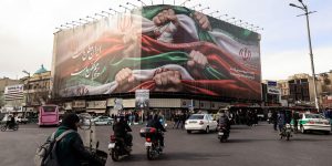 a large patriotic banner depicting the Iranian flag on Enghelab Square in Tehran on January 14, 2026