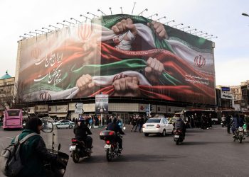 a large patriotic banner depicting the Iranian flag on Enghelab Square in Tehran on January 14, 2026
