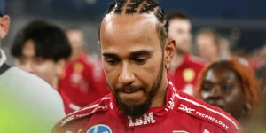 Lewis Hamilton bites his lip as he looks down in Abu Dhabi