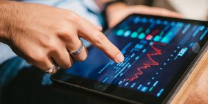Man checking stock market data on tablet