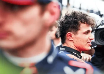Lando Norris chats in parc ferme with Max Verstappen looming large in the foreground